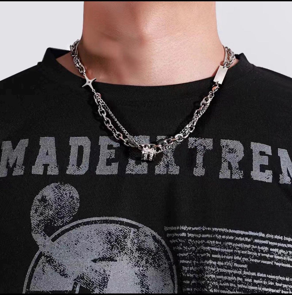 Model wearing Samvee men's layered silver Double Cross and Lucky Bead necklace